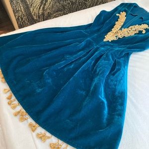 Rich velvet lined teal ASOS dress with gold embellishments and tassels
